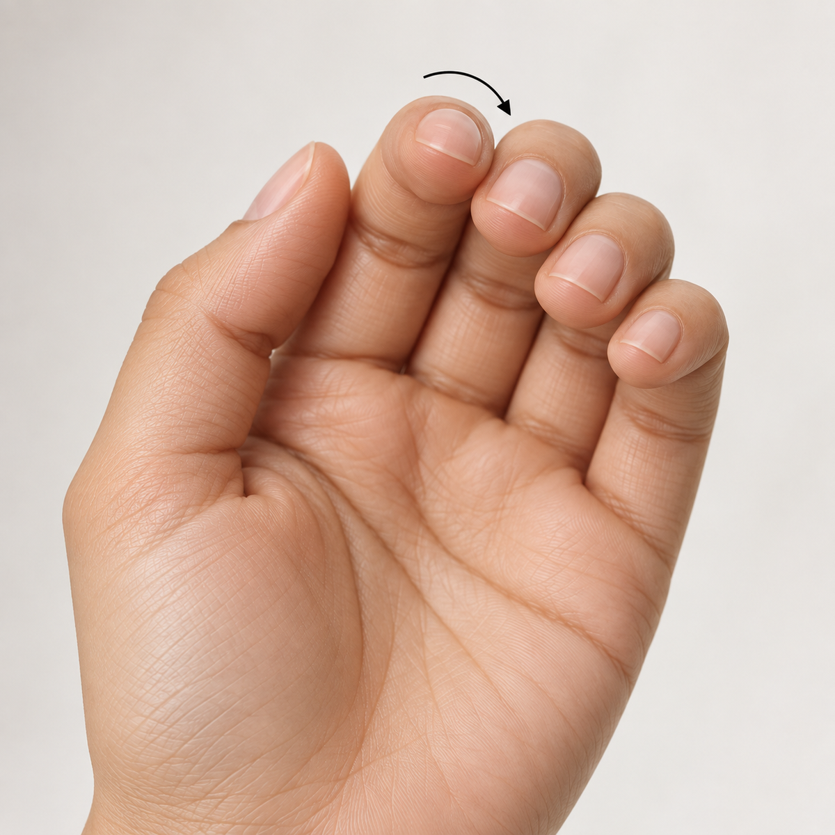 A hand with the fingers curled and the nails facing the camera, the angle used to judge the curve across the natural nail
